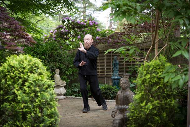 Dr. Neville pactices the discipline of taijiquan in his garden.